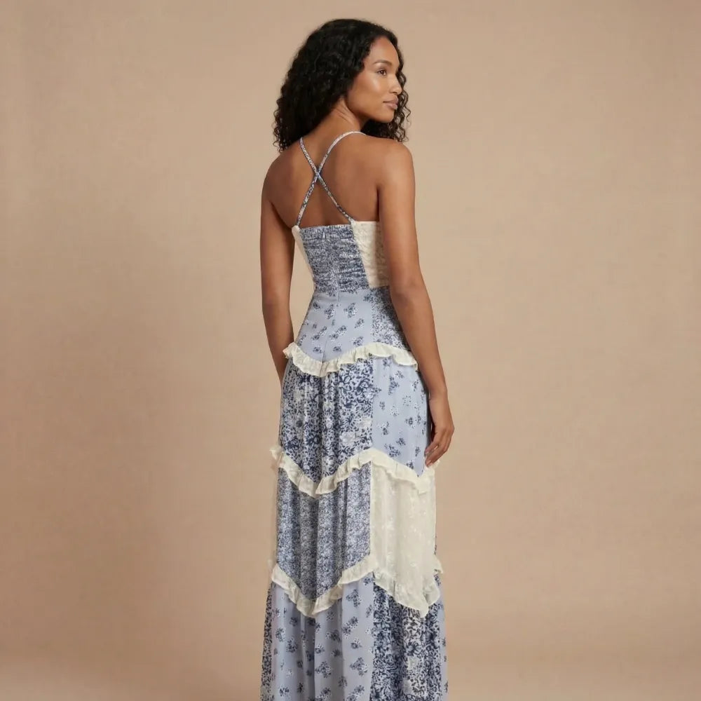 Back view of blue floral maxi dress with crisscross straps and cream ruffled tier details