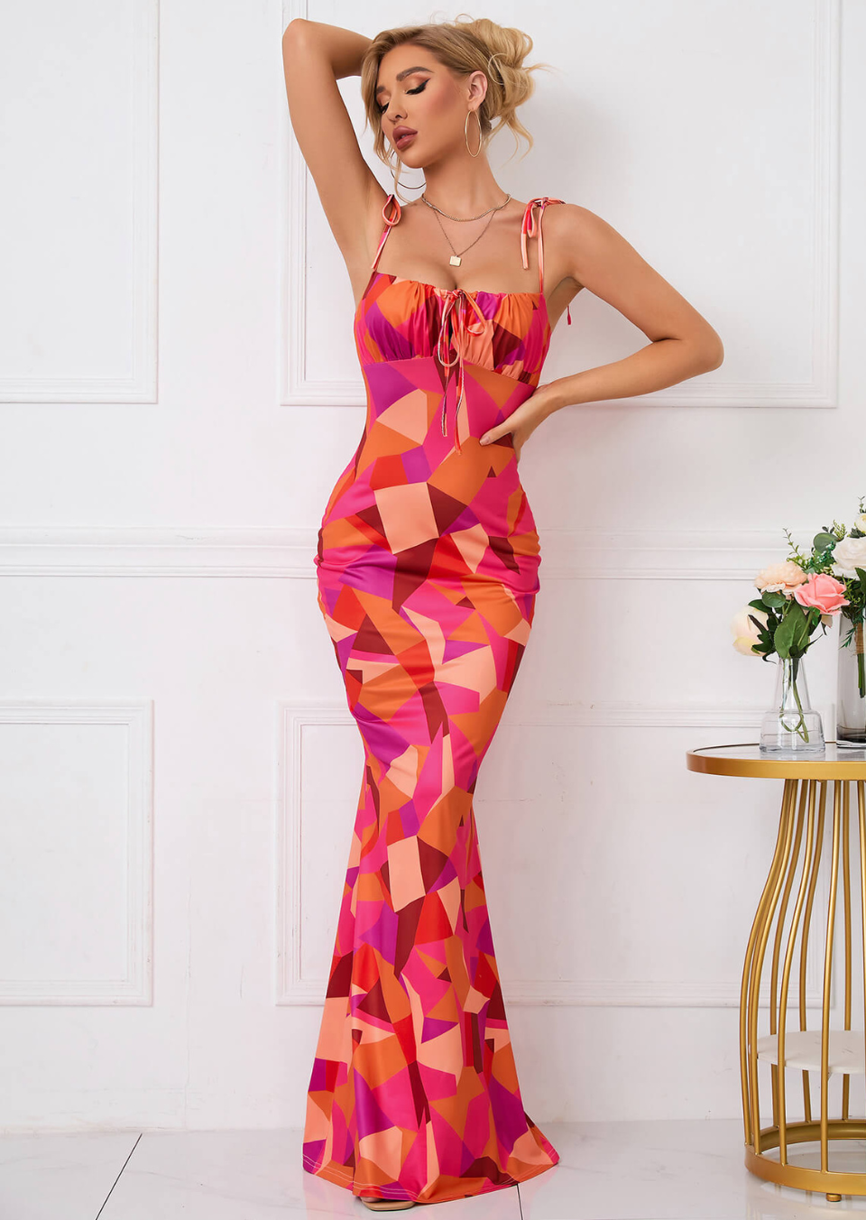 Front view of a square neck floral maxi dress with tie straps and bodycon fit in pink and orange