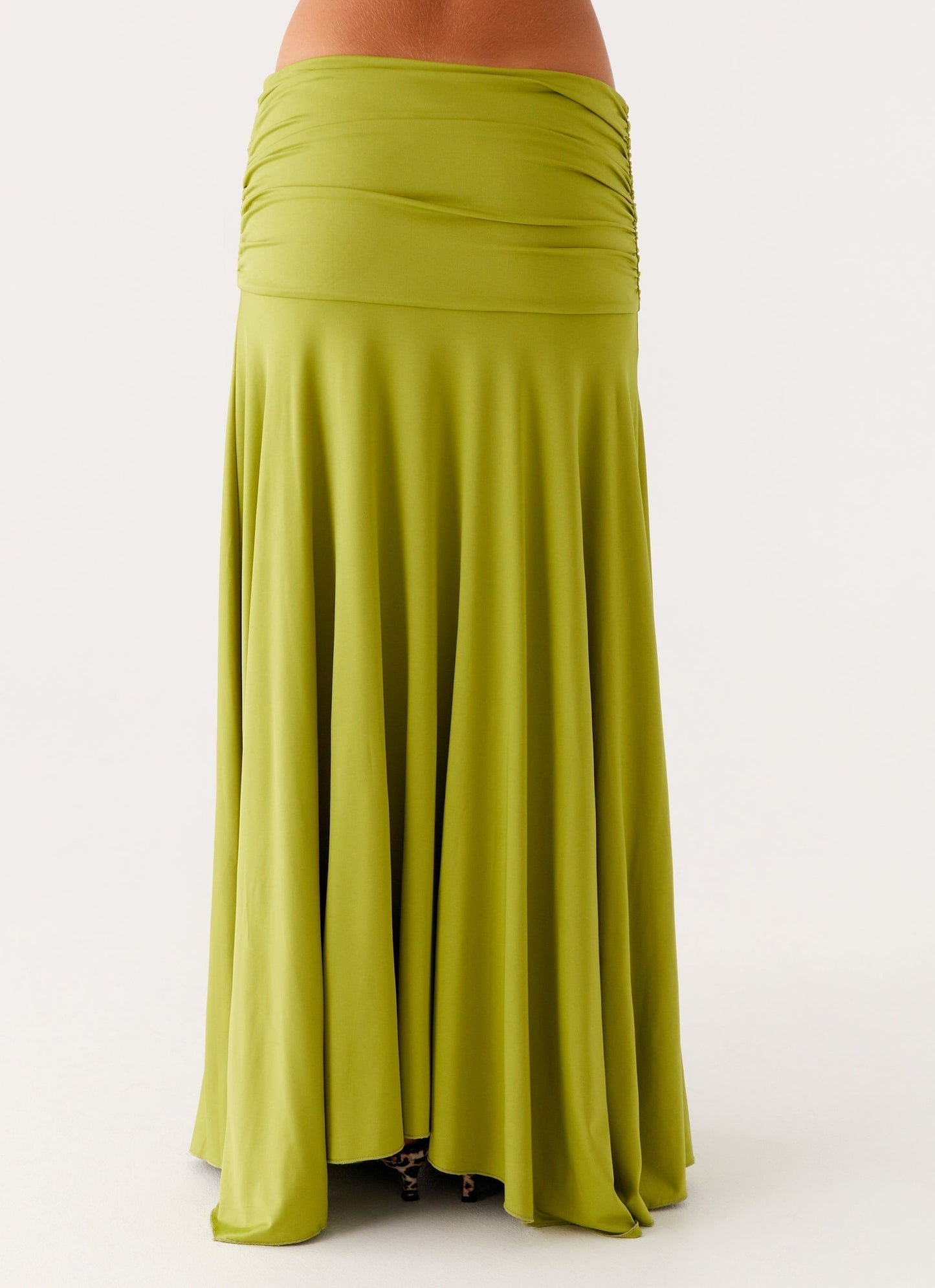 Back close-up of lime green maxi dress showing ruched waist panel and flowing skirt fabric