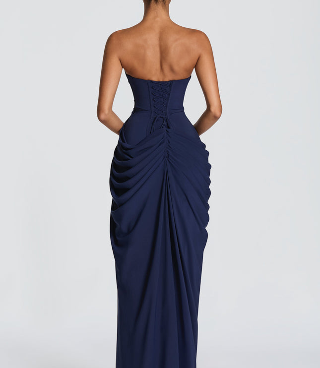 Back view navy strapless corset maxi womens dress showing lace-up corset detail and draped skirt