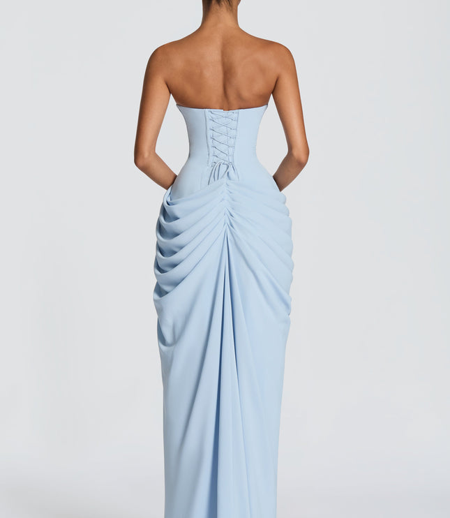Back view light blue strapless corset maxi dress with lace-up detail and ruched skirt drape
