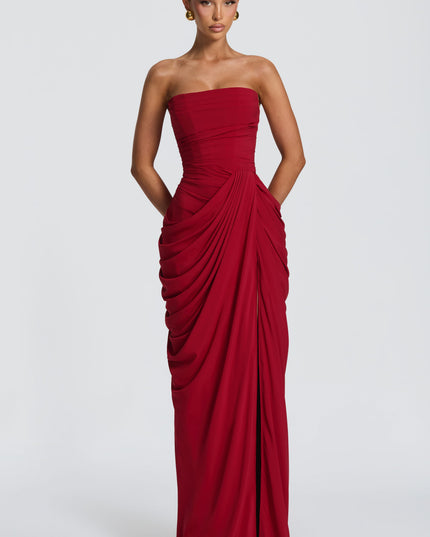 Deep red strapless corset maxi womens dress with draped skirt and high thigh split, front view