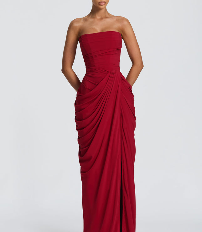 Deep red strapless corset maxi womens dress with draped skirt and high thigh split, front view