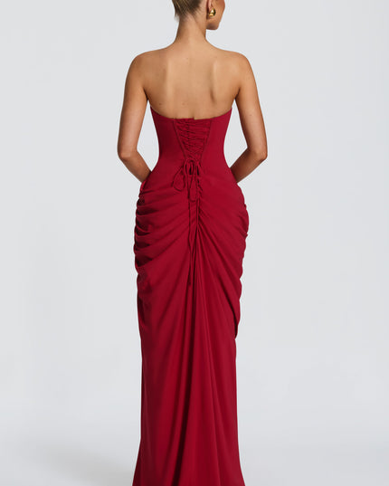 Back view deep red strapless corset maxi dress with lace-up corset closure and ruched drape