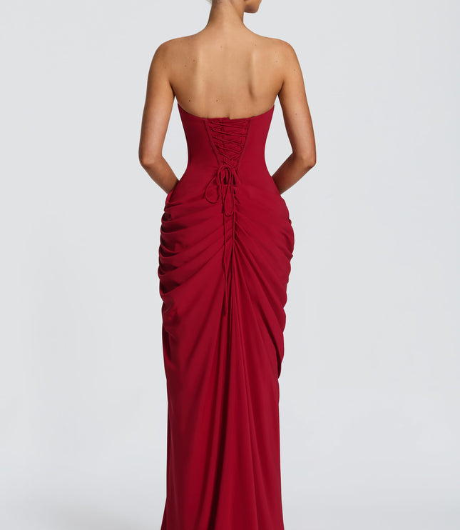 Back view deep red strapless corset maxi dress with lace-up corset closure and ruched drape