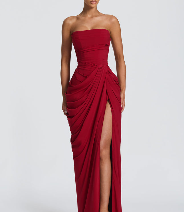Deep red strapless corset maxi womens dress with asymmetric draped skirt and thigh-high slit