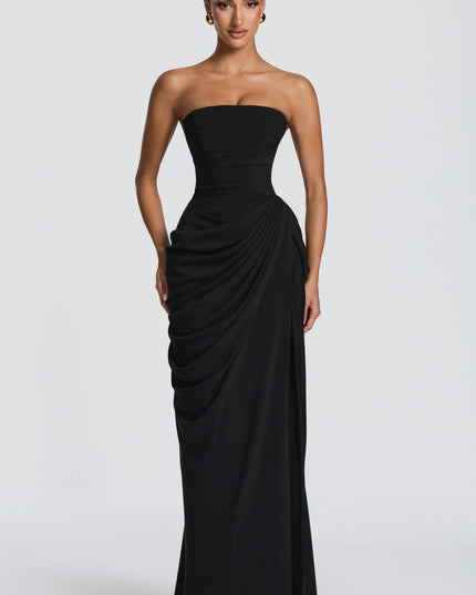 Black strapless maxi corset dress with draped skirt and thigh split, front view