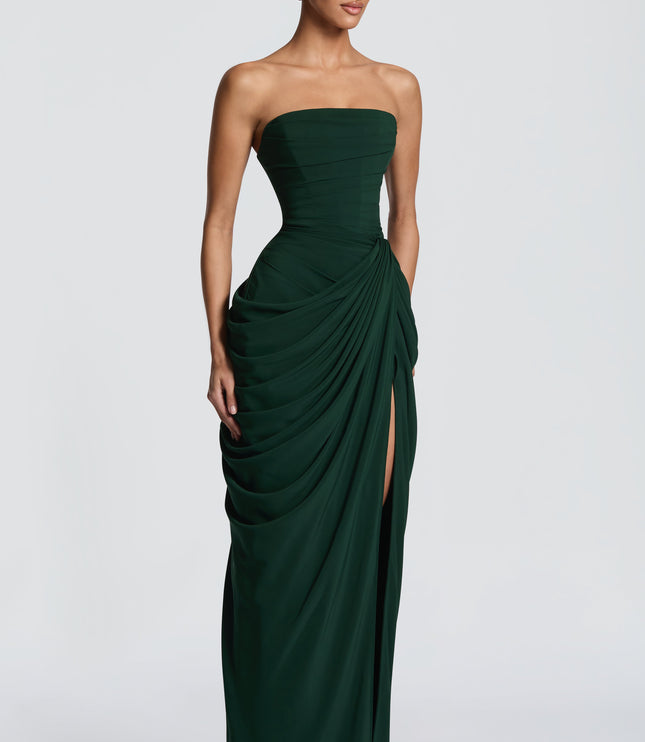 Side view of dark green strapless maxi dress with draped skirt and high leg slit