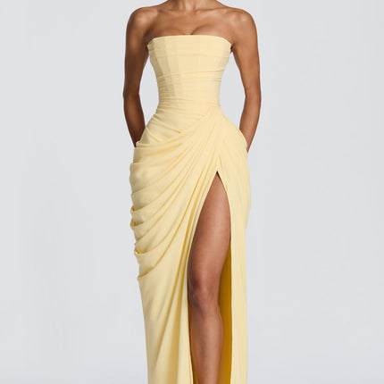 Pale yellow strapless corset maxi womens dress with draped skirt and high thigh split, front view