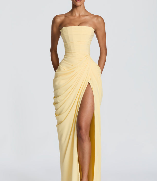 Pale yellow strapless corset maxi womens dress with draped skirt and high thigh split, front view