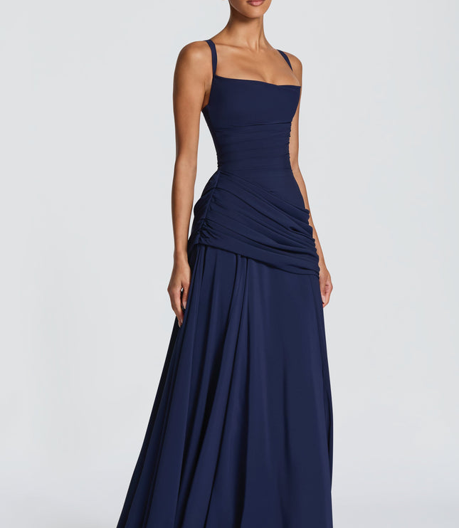Three-quarter view navy square neck wedding guest maxi dress with ruched waist and flowy skirt