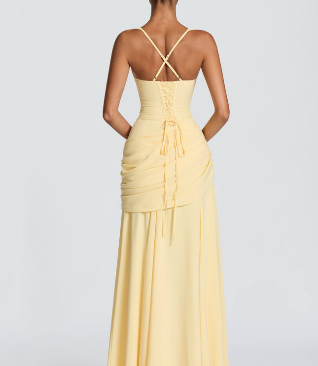 Back view of butter yellow square neck maxi dress with crisscross straps and lace-up detail