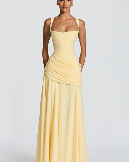 Full length butter yellow square neck wedding guest maxi dress with draped skirt overlay