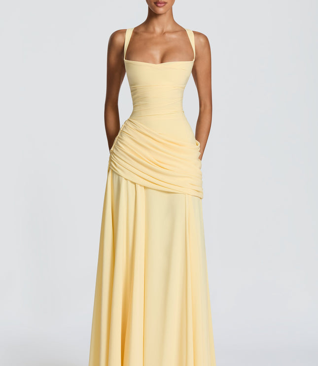 Full length butter yellow square neck wedding guest maxi dress with draped skirt overlay
