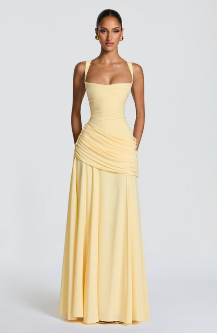 Full length butter yellow square neck wedding guest maxi dress with draped skirt overlay