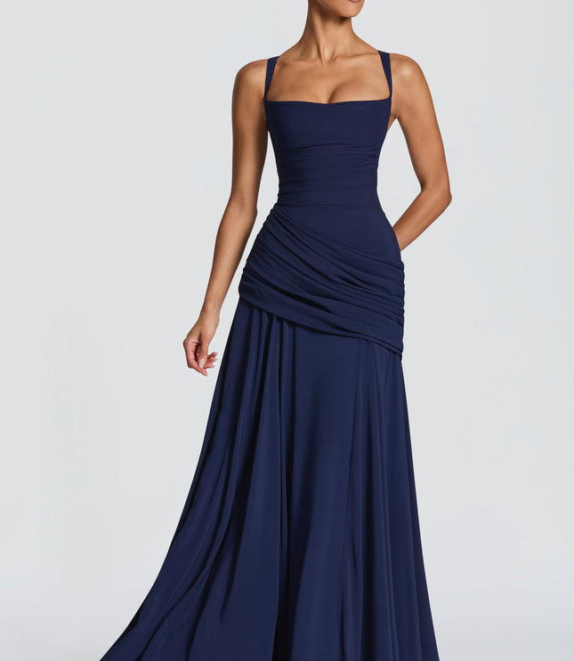 Three-quarter view navy blue square neck womens dress with ruched hip and flowing maxi skirt