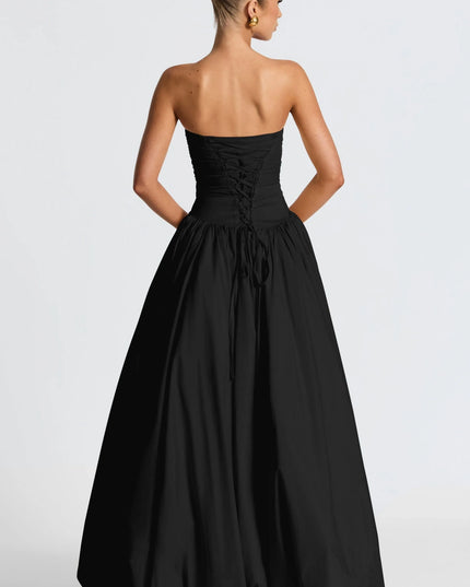 Back view black strapless high low maxi dress with lace-up corset detail and long skirt