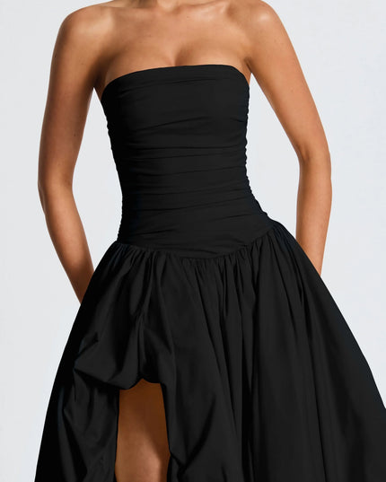 Close-up of black strapless ruched bodice on high low maxi cocktail dress with gathered skirt