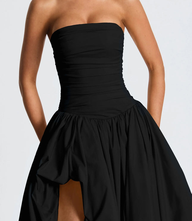 Close-up of black strapless ruched bodice on high low maxi cocktail dress with gathered skirt