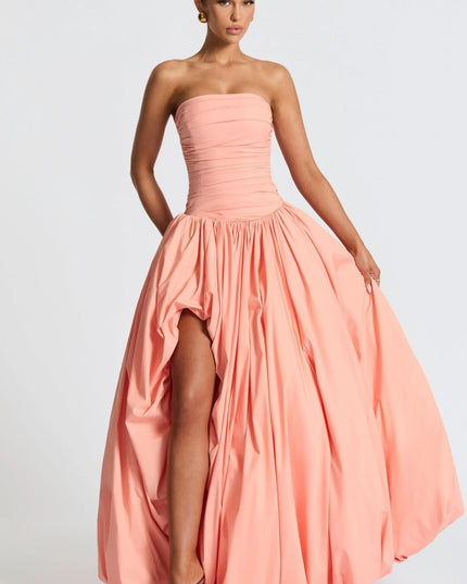 Peach strapless high low maxi cocktail dress with ruched bodice and voluminous bubble hem skirt