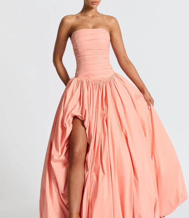 Peach strapless high low maxi cocktail dress with ruched bodice and voluminous bubble hem skirt