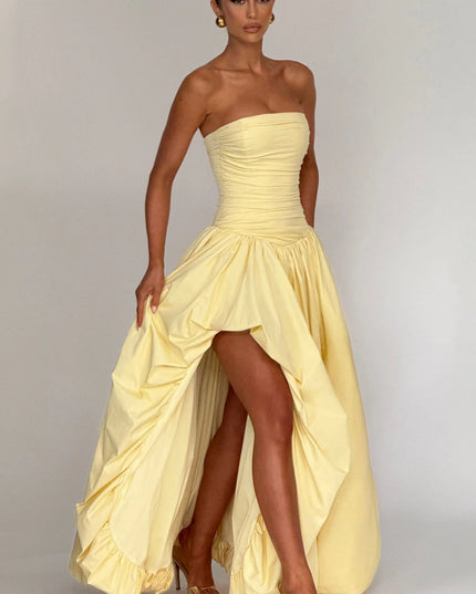 Studio front view pale yellow strapless high low maxi dress with gathered skirt and high slit