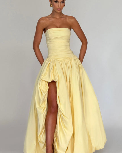 Front view pale yellow strapless womens dress with ruched bodice, gathered waist, and high slit