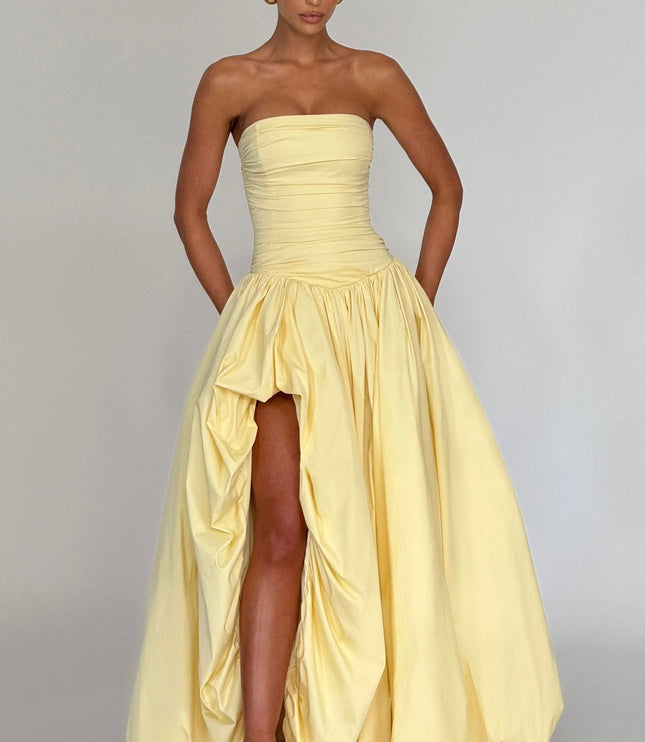 Front view pale yellow strapless womens dress with ruched bodice, gathered waist, and high slit