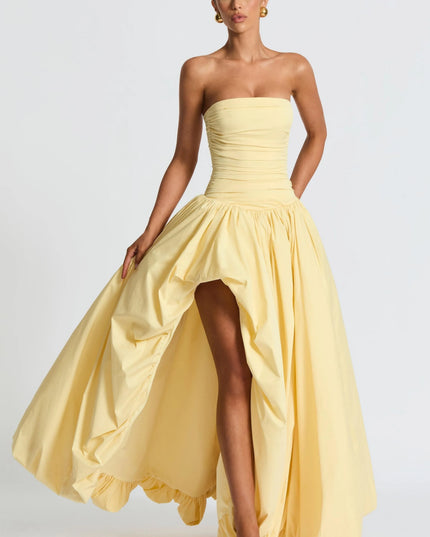 Pale yellow strapless high low maxi cocktail dress with ruched bodice and voluminous skirt