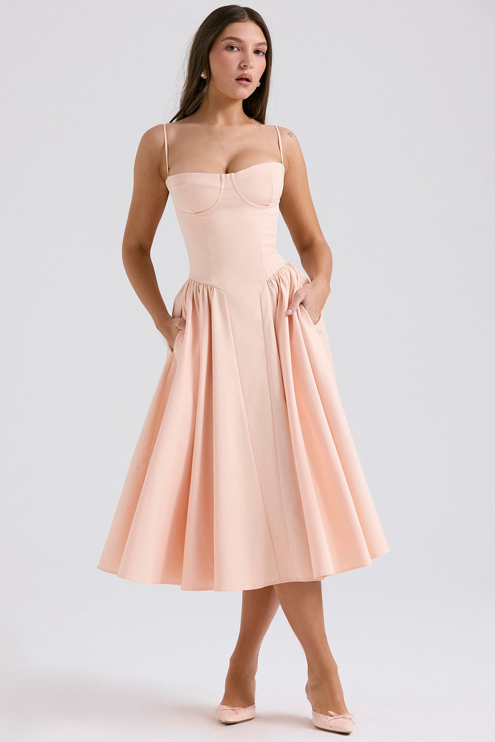 Blush pink cocktail midi dress with adjustable straps, structured cups, and side pockets