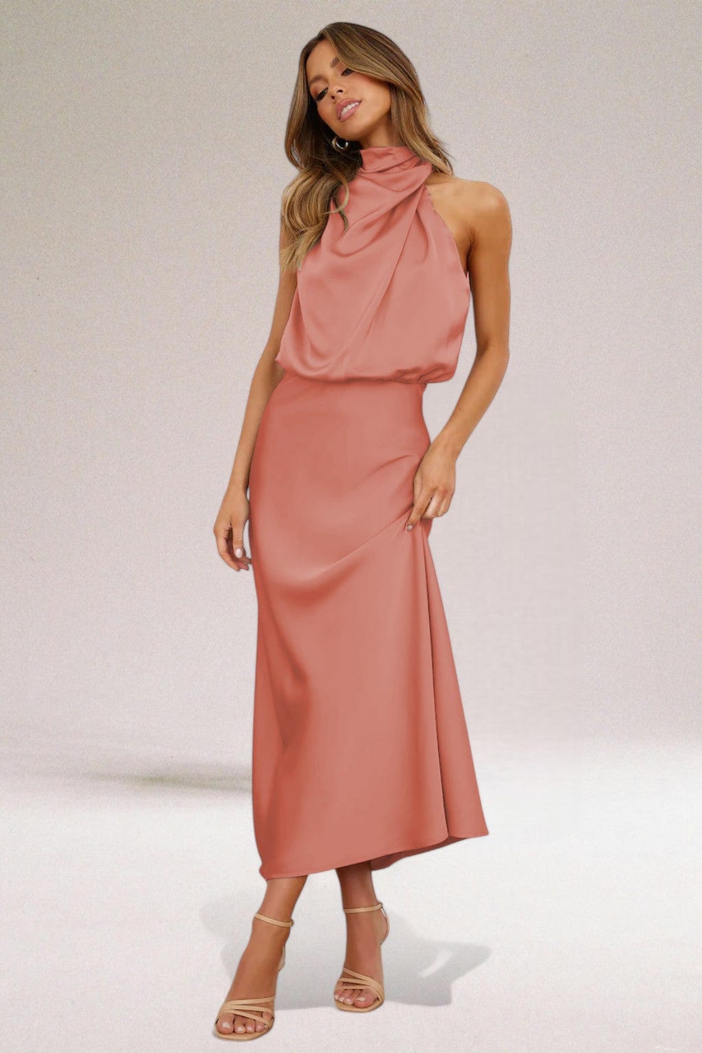 Coral halter midi dress with gathered neckline and flowing satin cocktail skirt