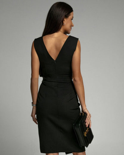 Back view of black pleated V neck midi dress with sleeveless cut and tailored fit