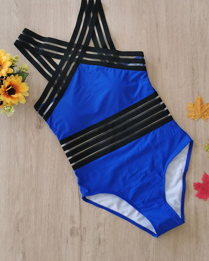 Blue and black criss cross one piece swimsuit laid flat with sheer stripe accents