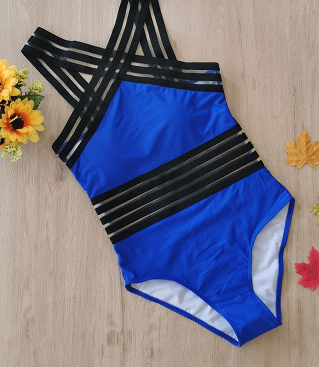 Blue and black criss cross one piece swimsuit laid flat with sheer stripe accents