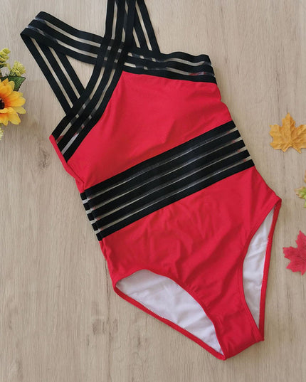 Red one piece swimsuit with black criss cross halter straps and sheer striped bands