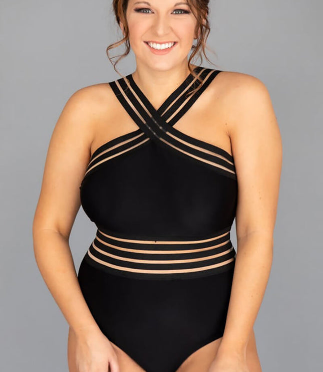 Studio view of black criss cross halter one piece swimsuit on model with gray background