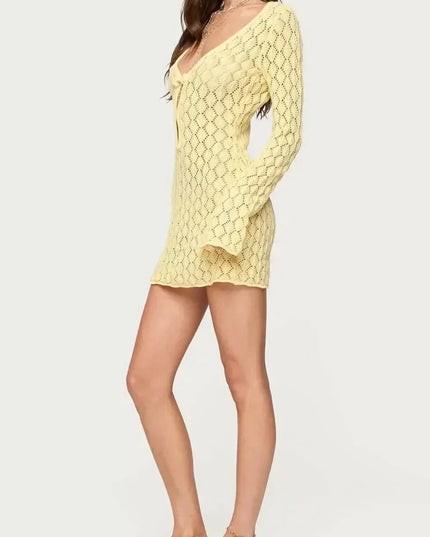 Side view of yellow crochet tie front mini dress with long sleeves and short hem