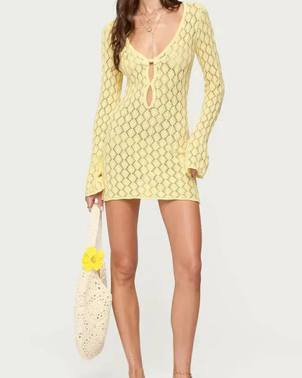 White crochet tie front mini dress with deep V neckline, long sleeves, and short hem
