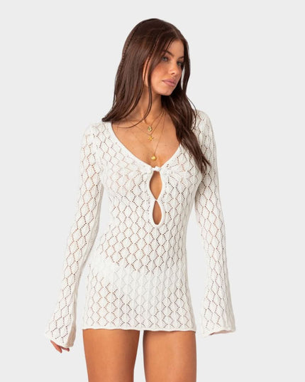 Front view of white summer crochet mini dress with tie front and flared sleeve cuffs