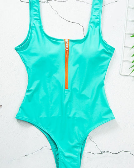 Turquoise one piece swimsuit with scoop neck and front zipper, flat lay view