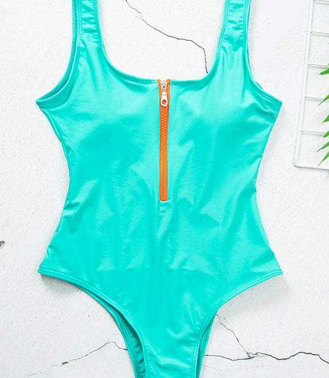 Turquoise one piece swimsuit with scoop neck and front zipper, flat lay view