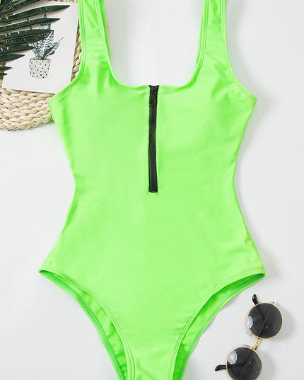 Neon green one piece swimsuit with black front zipper and scoop neckline on model