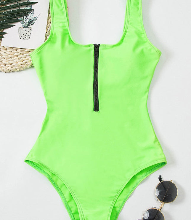 Neon green one piece swimsuit with black front zipper and scoop neckline on model