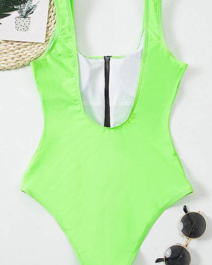 Neon green one piece bathing suit laid flat with black zipper and wide shoulder straps