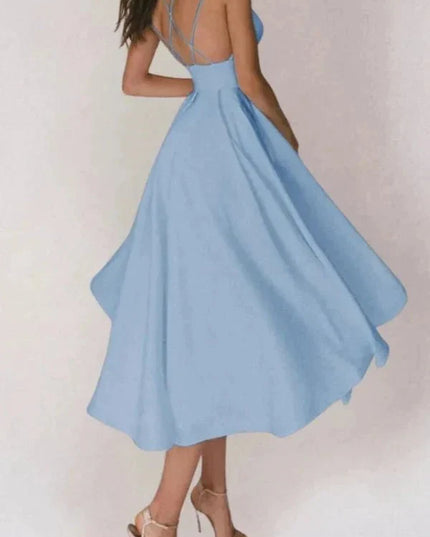 Back view of light blue V neck midi dress with open back and strappy heels