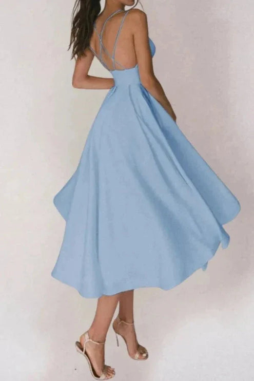 Back view of light blue V neck midi dress with open back and strappy heels