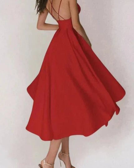 Back view of red open back midi dress with crisscross straps and flared skirt