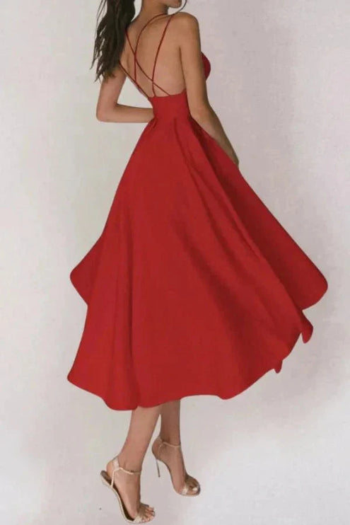 Back view of red open back midi dress with crisscross straps and flared skirt