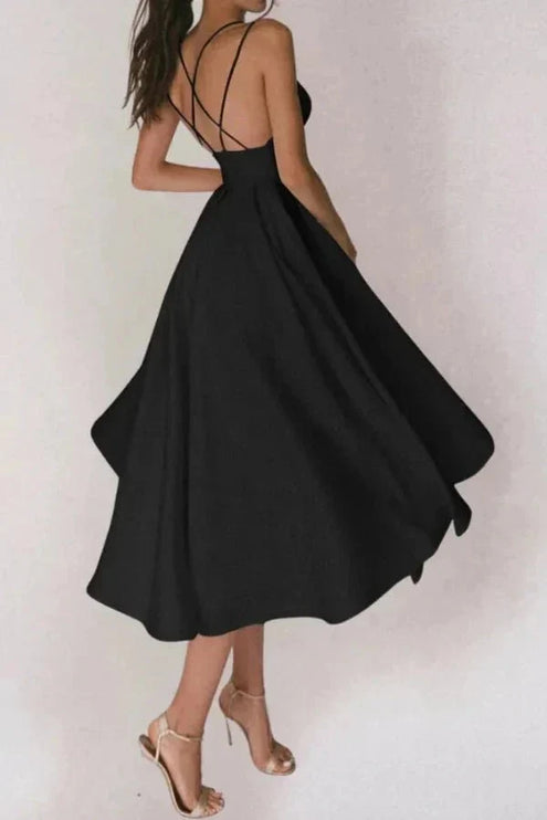 Back view of black open back midi dress with crisscross straps and flowy skirt