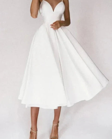 White V neck midi dress with thin straps and flared skirt for wedding guest